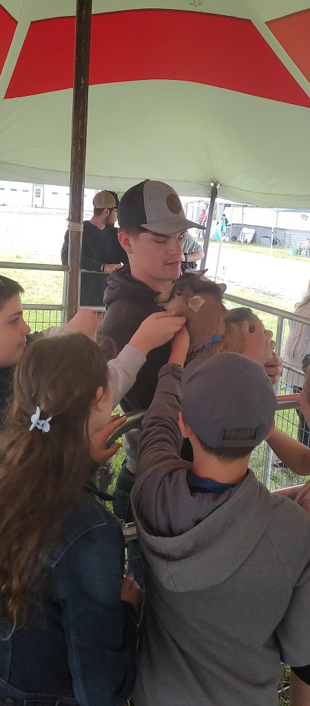 Photo of Waterville student Logan Roberts holding a goat