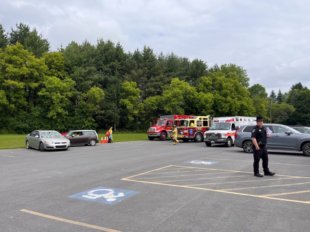 photo of a car crash involving two cars and pulling up to the accident is two fire trucks and an ambulance