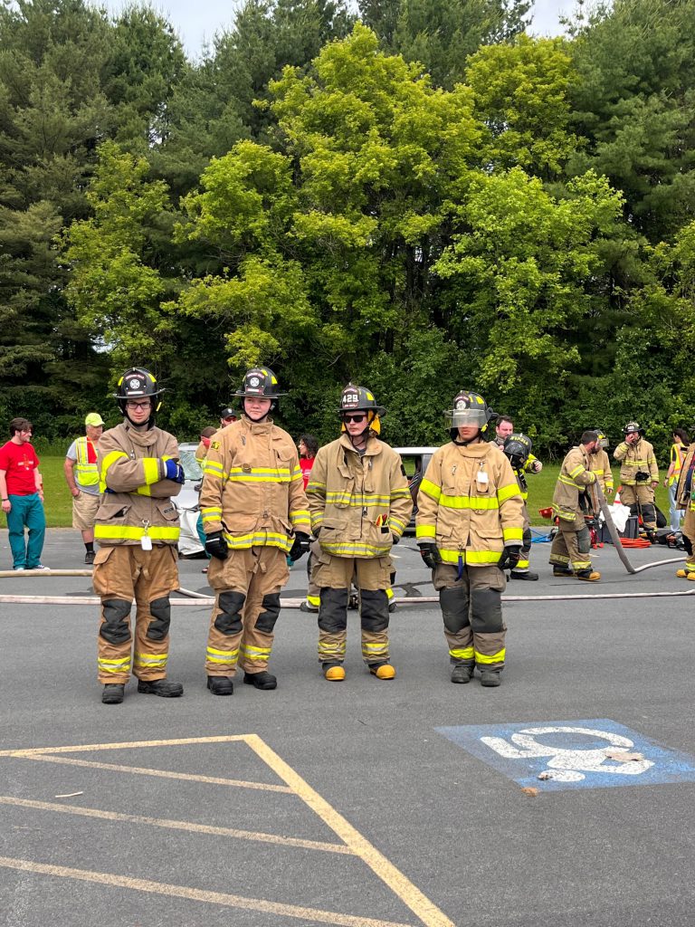 Photo of Cody Coon Abigail Dapson Noah Jandreau Wyatt Keenan in their volunteer firefighter gear