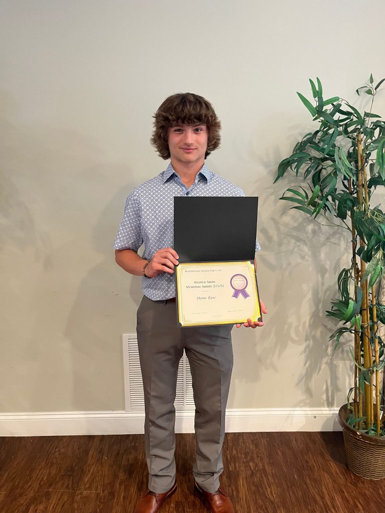 Photo of student holding an award