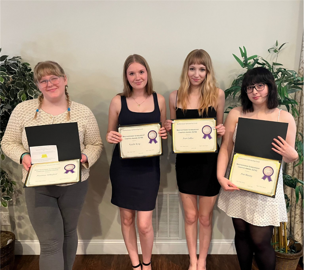 Photo of four students holding certificates