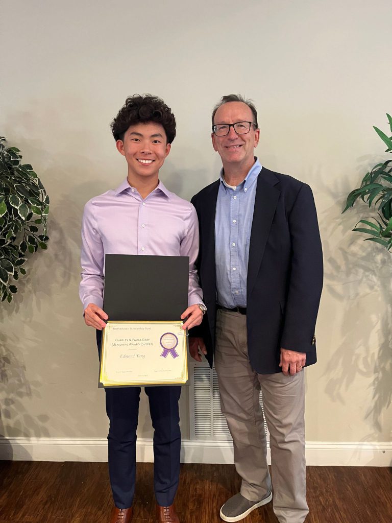 Photo of student holding a certificate along with Mr. Gray