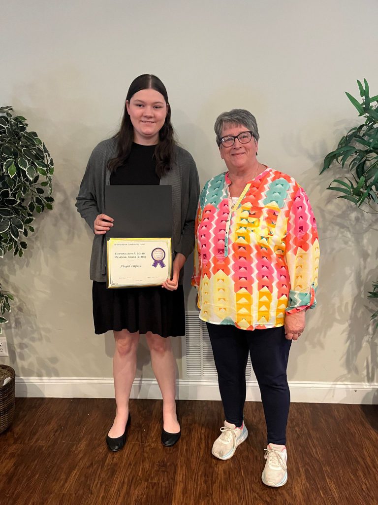 Photo of student holding a certificate with Mrs. Sigsbee sponsor of the award