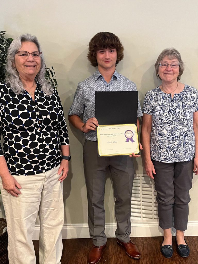 Photo of student holding certificate with two sponsors
