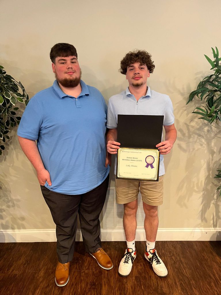Photo of student holding a certificate along with sponsor
