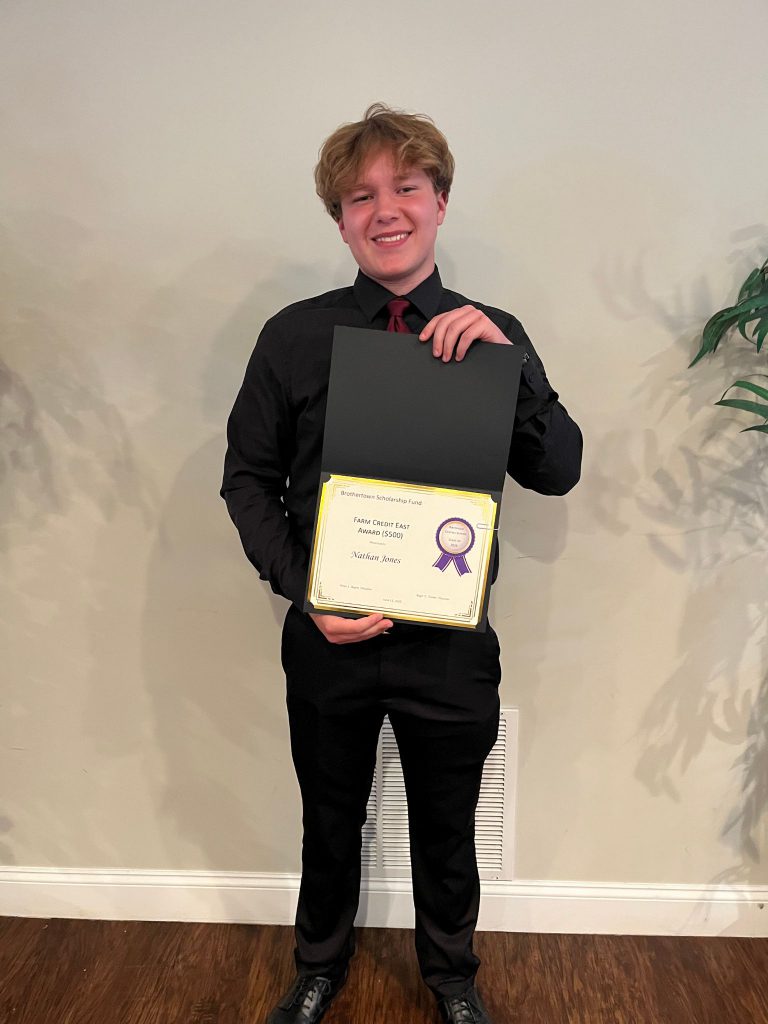 Photo of student holding a certificate
