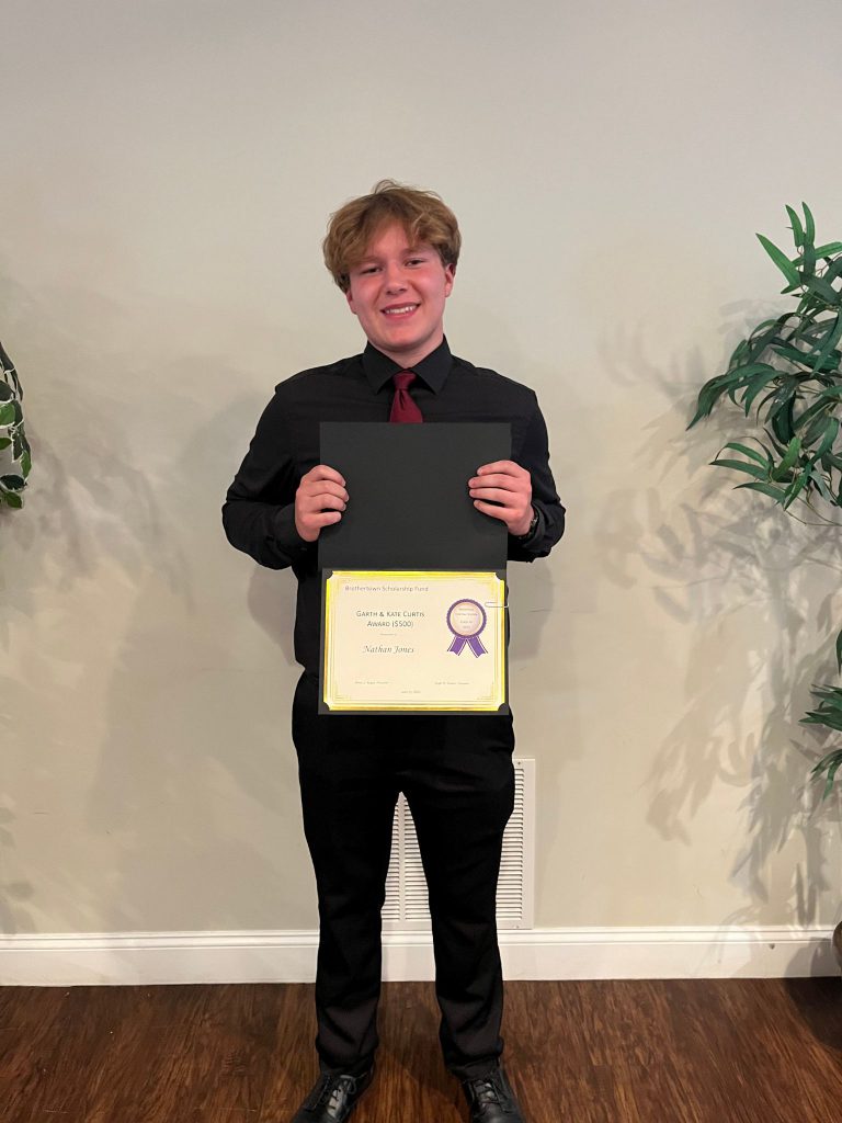 Photo of student with a certificate