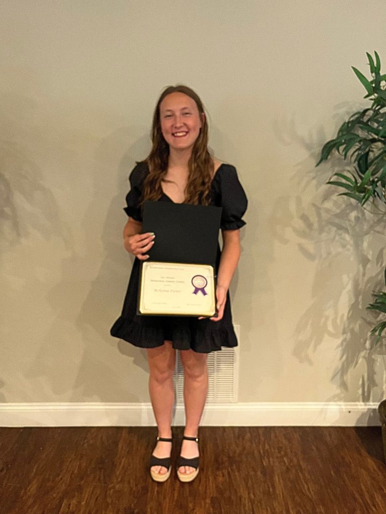 Photo of student holding certificate