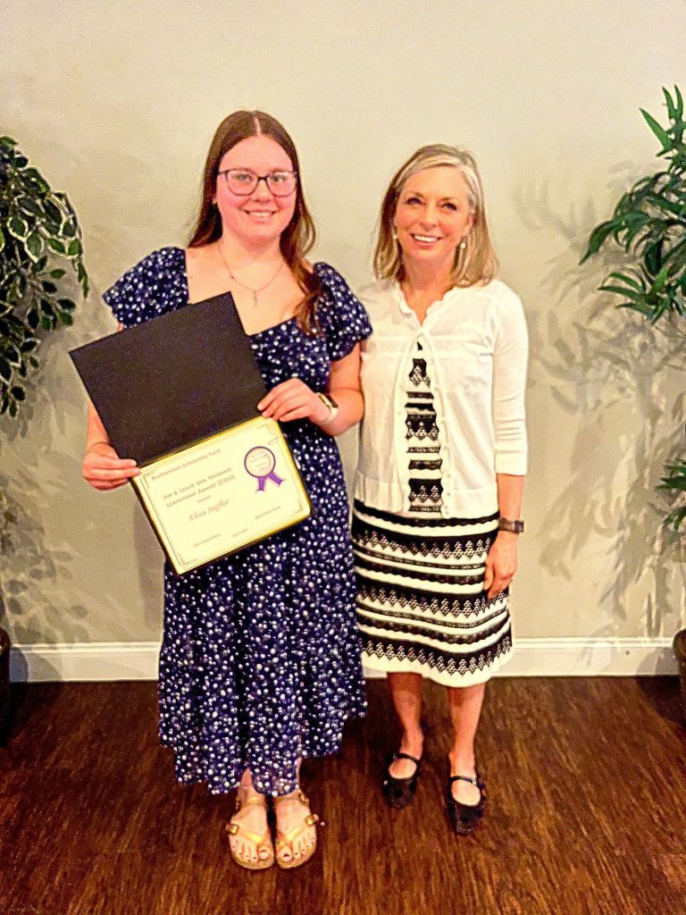 Photo of student holding a certificate with sponsor