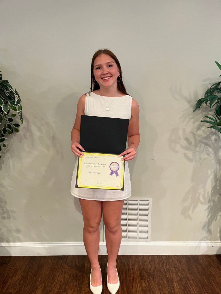 Student holding a certificate
