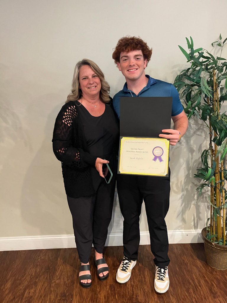Photo of student holding a certificate along with the sponsor