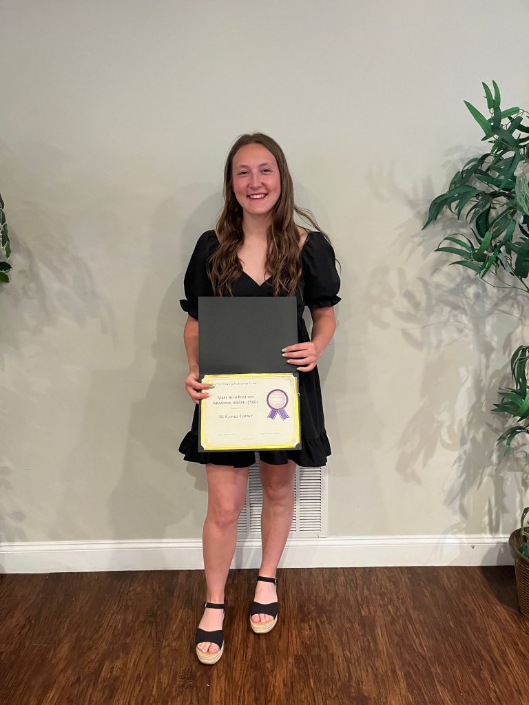 Photo of student holding certificate