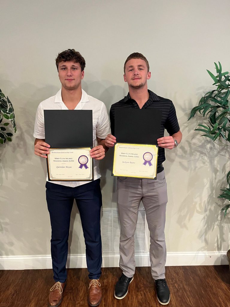 Photo of two students holding certificates