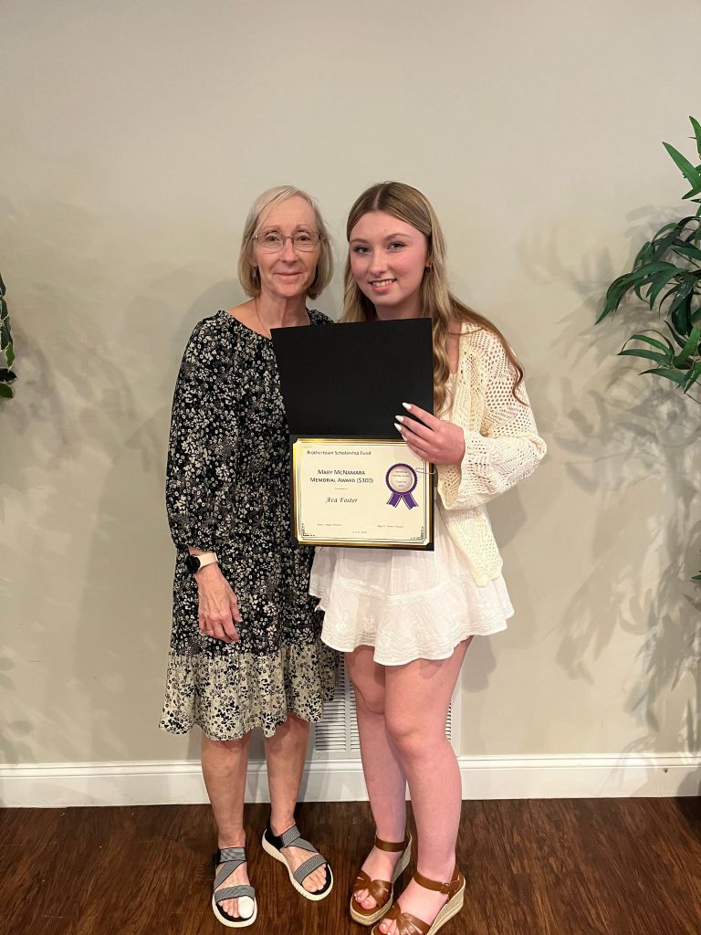 Photo of student holding a certificate along with sponsor