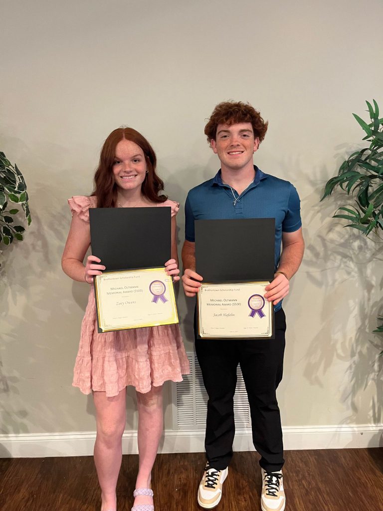 Photo of two students holding certificates