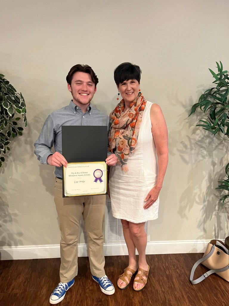 Photo of student holding certificate with sponsor