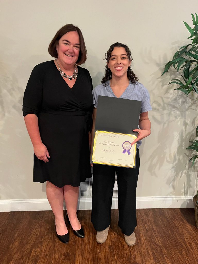 Photo of student holding a certificate with sponsor