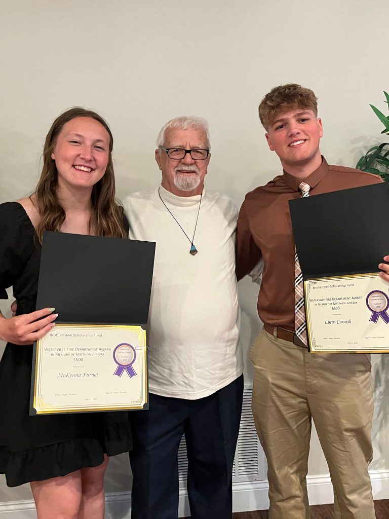 Photo of two students holding a certificate along with sponsor
