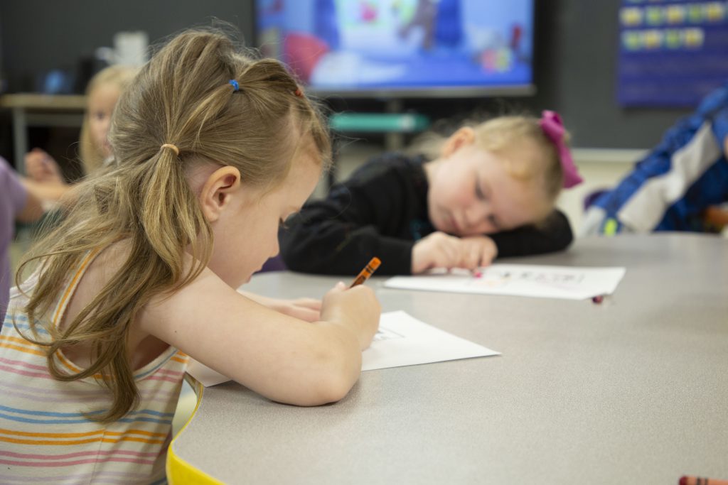 two kindergarten students coloring