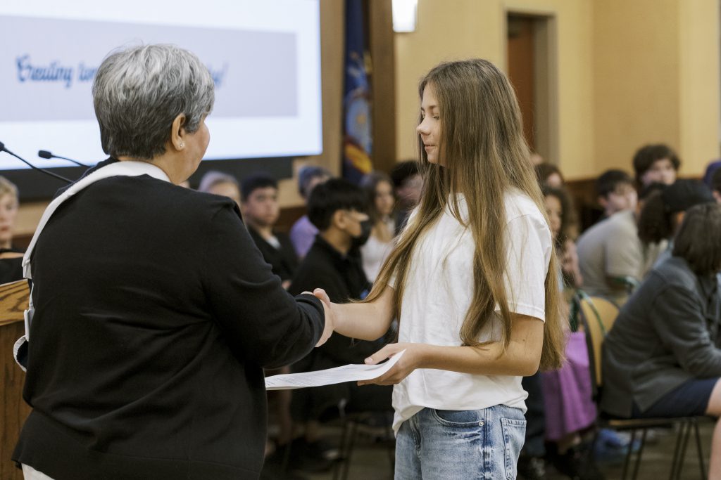 Photo of P-TECH student receiving a welcome letter
