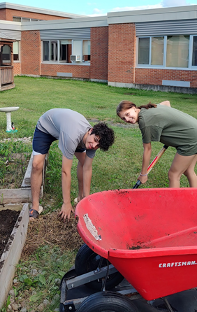 two FFA students working in the garden 