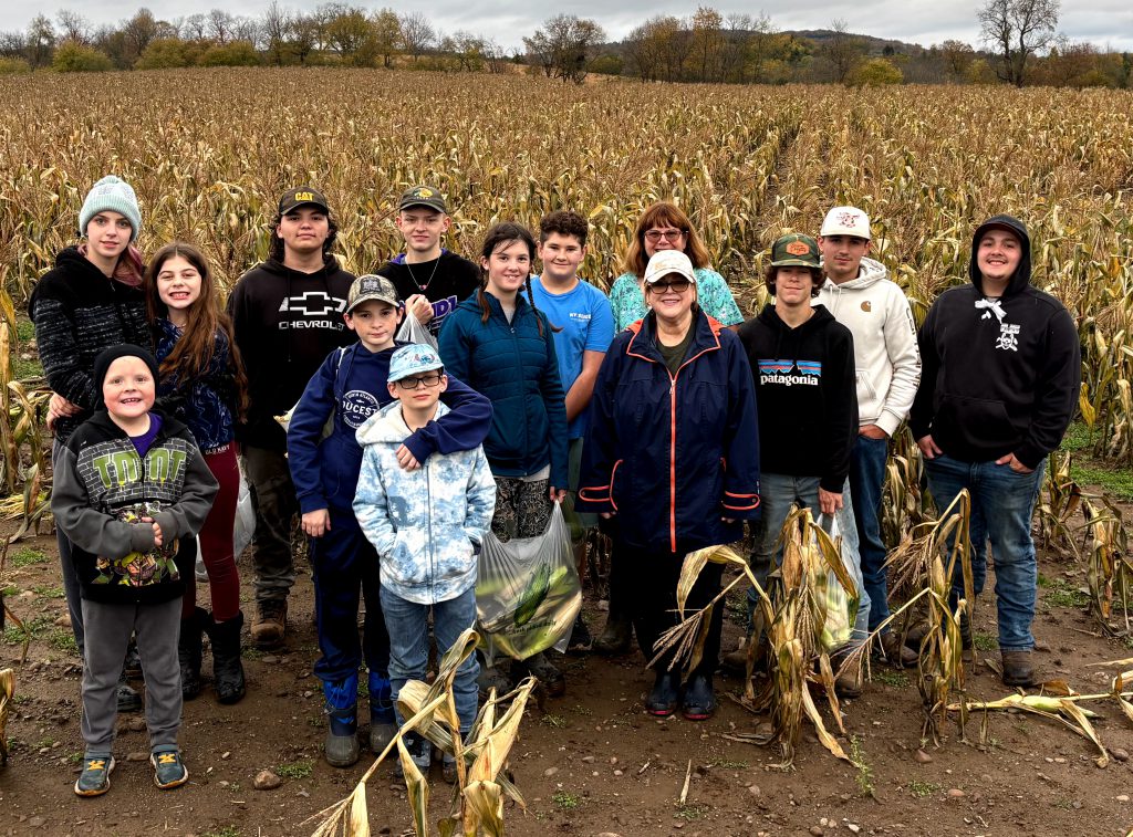 group photo of FFA students in a corn field